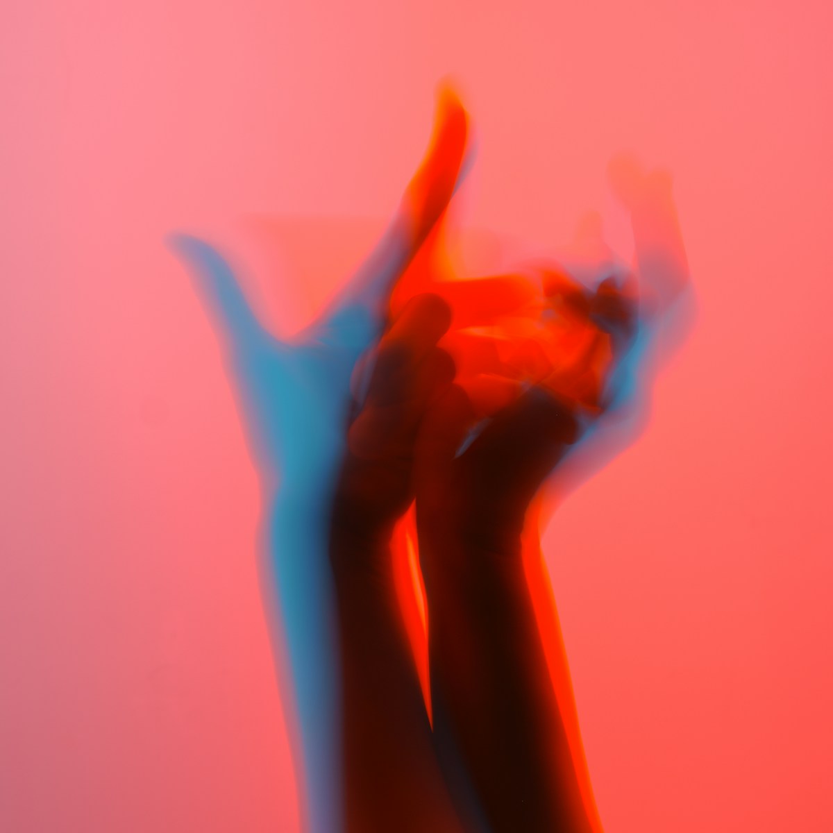 a blurry image of two hands holding something